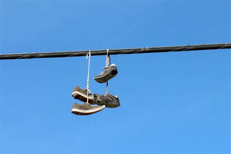 running shoes hanging from power lines.